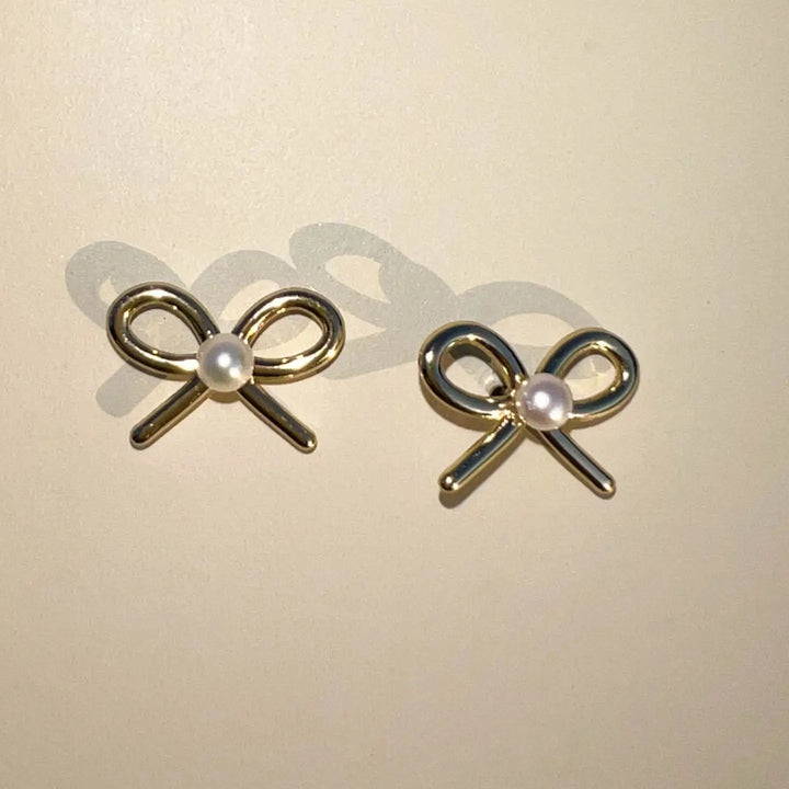 The Pearl Bow Stud Earrings [Nickel & Suede]